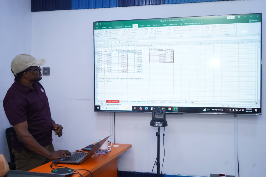 Facilitator demonstrating Excel lookup formulas on a large screen
