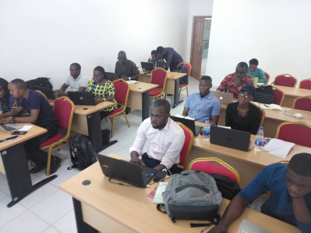 Full classroom of professionals completing a hands-on Excel workshop