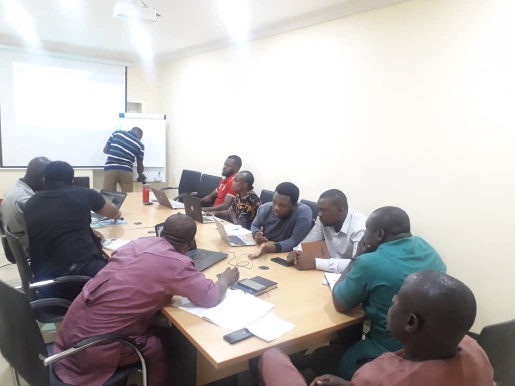 Boardroom-style training session with a facilitator at the whiteboard