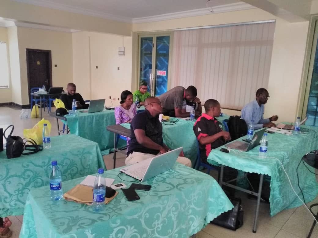 Delegates working on laptops during an offsite capacity development workshop